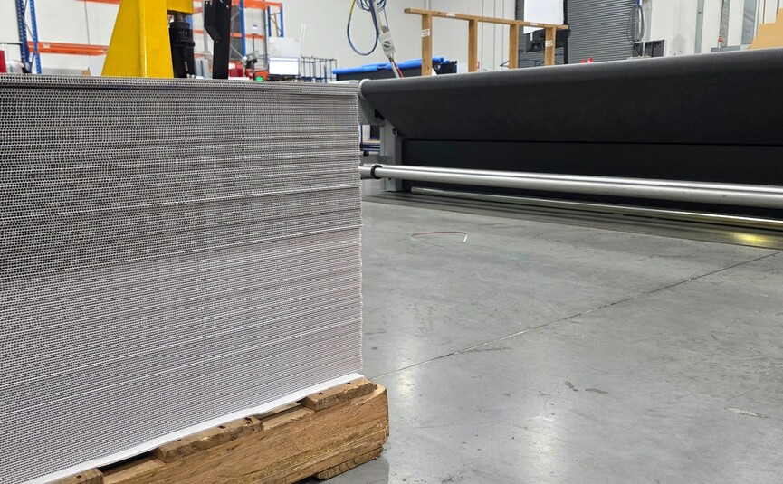 Cut Corflute sheets beside automated production equipment at Mediapoint